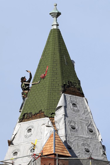Reagen Kornelsen from Racka Roofing grabs a selfie while working atop the bell tower at Calvary Temple on Hargrave Street in Winnipeg on Thurs., Nov. 4, 2021. The tower is the only remaining part of a large Baptist church constructed in 1893-94 at a cost of $45,000. The current Pentecostal parish congregation was aided by a $25,000 Heritage Resources Conservation Grant from the province to replace the current shingles with cedar.  KEVIN KING/Winnipeg Sun/Postmedia Network