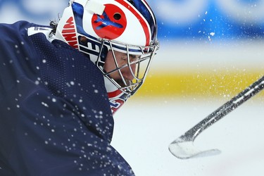 Goaltender Connor Hellebuyck is sprayed with snow during Winnipeg Jets practice at Canada Life Centre on Mon., Nov. 8, 2021.  KEVIN KING/Winnipeg Sun/Postmedia Network