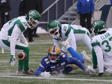 Winnipeg Blue Bombers WR Drew Wolitarsky (centre) loses the football near the Saskatchewan Roughriders end zone in the CFL West Final in Winnipeg on Sunday, Dec. 5, 2021.