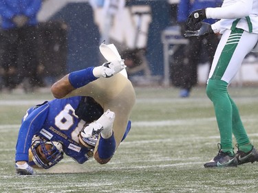 Winnipeg Blue Bombers WR Kenny Lawler is flipped after a catch against the Saskatchewan Roughriders in the CFL West Final in Winnipeg on Sunday, Dec. 5, 2021.
