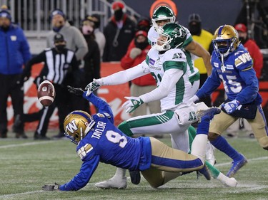 Winnipeg Blue Bombers DB Nick Taylor (left) breaks up a pass intended for Saskatchewan Roughriders WR Mitchell Picton to sew up the CFL West Final in Winnipeg on Sunday, Dec. 5, 2021.