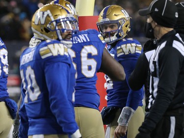 Winnipeg Blue Bombers QB Sean McGuire (right) celebrates his rushing touchdown against the Saskatchewan Roughriders in the CFL West Final in Winnipeg on Sunday, Dec. 5, 2021.