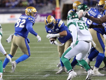 Winnipeg Blue Bombers RB Andrew Harris carries the ball against the Saskatchewan Roughriders in the CFL West Final in Winnipeg on Sunday, Dec. 5, 2021.