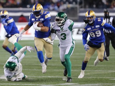 Winnipeg Blue Bombers RB Andrew Harris carries the ball against the Saskatchewan Roughriders in the CFL West Final in Winnipeg on Sunday, Dec. 5, 2021.
