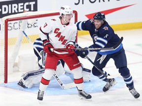 Winnipeg Jets defenceman Brenden Dillon (right) concerns himself with Carolina Hurricanes forward Andrei Svechnikov in front of goaltender Connor Hellebuyck in Winnipeg on Tues., Dec. 7, 2021. Dillon says the team needs to keep its penalty killing momentum after killing of five against Seattle on Thursday. KEVIN KING/Winnipeg Sun/Postmedia Network
