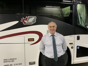 John Fehr, general manager of Beaver Bus Lines, stands in front of one of his buses at a press conference on Monday, Dec. 13, 2021, in Winnipeg to announce that the Manitoba government is launching a new, $1.92-million program to support bus and air charter transportation companies that have been affected by the COVID-19 pandemic and public health restrictions.