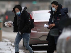People wear masks while in public in Winnipeg during the COVID-19 pandemic on Friday, Dec. 17. 2021.