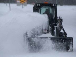 A piece of equipment clears snow in a park in Winnipeg on Tuesday.