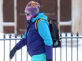 A person wears a mask while walking along a sidewalk in Winnipeg.   Chris Procaylo,  Thursday Dec. 30. 2021 Winnipeg Sun
