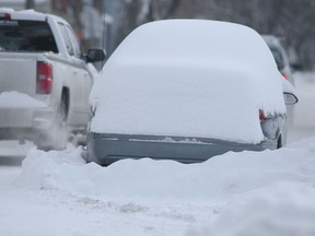 A snow covered vehicle parked on a residential street in Winnipeg on Dec. 30. Chris Procaylo/Winnipeg Sun