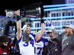 Jesse Briggs (34) of the Winnipeg Blue Bombers celebrates their victory with the Grey Cup following the 108th Grey Cup CFL Championship Game against the Hamilton Tiger-Cats at Tim Hortons Field on Dec. 12, 2021 in Hamilton.