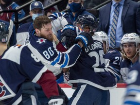 Colorado Avalanche right wing Logan O'Connor (25) goes after Winnipeg Jets left wing Pierre-Luc Dubois (80) after hitting Colorado Avalanche centre Nazem Kadri on the play during the second period at Ball Arena on Thursday, Jan 6, 2022.