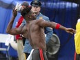 A N.J. State Police trooper, background, watches as Tampa Bay Buccaneers wide receiver Antonio Brown (81) throws his gloves into the stands during the third quarter of an NFL football game Sunday, Jan. 2, 2022, in East Rutherford, N.J.