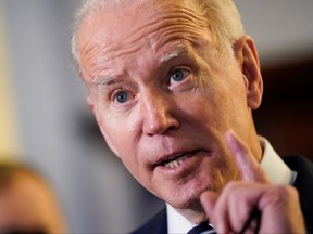 U.S. President Joe Biden gestures as he speaks to the media following Senate Democratic lunch, on Capitol Hill in Washington, D.C., Jan. 13, 2022.