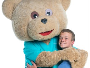 Brady Bobrowich, 2020-21 Champion Child for Children’s Hospital Foundation of Manitoba, hugs Dr. Goodbear, the foundation's mascot. Bobrowich presented a cheque for $37,000, the money he has raised over the past two years as Champion Child, to the surgical department at HSC Winnipeg Children’s Hospital to help purchase a much-needed tool – the Midas Rex MR7 pneumatic surgical drill.
