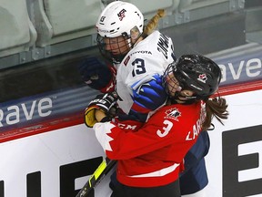 Team Canada's Jocelyne Larocque battles Team USA’s Natalie Buchbinder in first period action during the 2021 IIHF Women’s World Championship Gold medal game at the Winsport arena in Calgary on Tuesday, August 31, 2021.