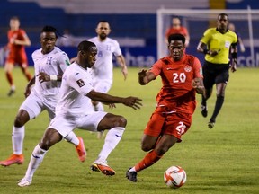 Canada's Jonathan David (right) vies for the ball with Honduras' Maynor Figueroa during their FIFA World Cup Qatar 2022 Concacaf qualifier match at the Olimpico Metropolitano Stadium in San Pedro Sula, Honduras on January 27, 2022. (Photo by AFP)