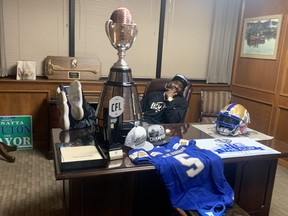 Willie Jefferson, the unofficial mayor of Beamont, Texas, puts his feet up on the desk of his good friend, the real mayor of Beaumont, Robin Mouton, moments after signing his new contract with the Bombers yesterday.