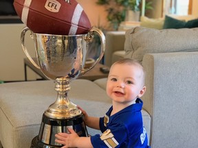 Winnipeg Blue Bombers long-snapper Mike Benson's son, Wilder, with the Grey Cup.