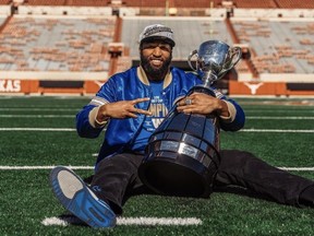 Former Longhorn Jackson Jeffcoat, of the Winnipeg Blue Bombers, poses with the Grey Cup at Darrell K Royal–Texas Memorial Stadium in Austin, Texas.