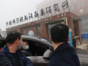 In this file photo taken on February 03, 2021 members of the World Health Organization (WHO) team investigating the origins of the COVID-19 coronavirus arrive by car at the Wuhan Institute of Virology in Wuhan in China's central Hubei province on February 3, 2021.