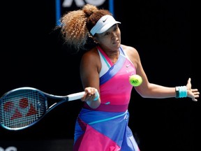 Japan's Naomi Osaka hits a return against Colombia's Camila Osorio during their women's singles match on day one of the Australian Open tennis tournament in Melbourne on January 17, 2022.