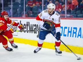 Florida Panthers left wing Jonathan Huberdeau (11) controls the puck in front of Calgary Flames left wing Andrew Mangiapane (88) during the first period at Scotiabank Saddledome in Calgary on Jan. 18, 2022.