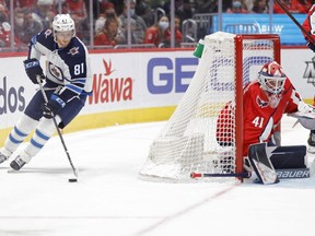 Winnipeg Jets left wing Kyle Connor (81) skates with the puck behind Washington Capitals goaltender Vitek Vanecek (41) during the second period at Capital One Arena in Washington, DC, on Jan. 18, 2022.