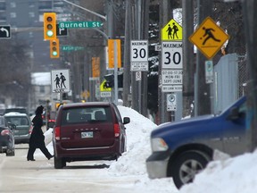 A person crosses a street near a school zone in Winnipeg on Tuesday. Chris Procaylo/Winnipeg Sun
