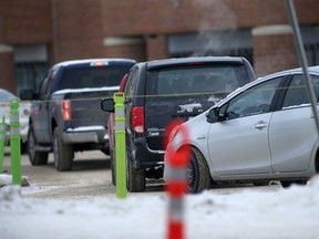 Vehicles line up to enter a COVID-19 testing site in Winnipeg on Tuesday, Jan. 11, 2022.