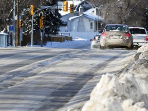 Vehicles on a rutted St. Mary’s Road in Winnipeg on Monday, Jan. 10, 2022.