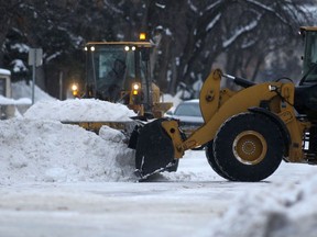 Heavy equipment clears snow from a street in Winnipeg.   Chris Procaylo,  Wednesday. January 12. 2022 Winnipeg Sun
