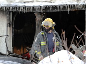 A Winnipeg Fire Paramedic service member at the scene of a fatal garage fire in the 900 block of Redwood Avenue in Winnipeg on Sunday, Jan. 16, 2022. One person was found dead in the structure after a call at about 8:30 a.m., with crews finding the structure engulfed in flames. Members of the Winnipeg Police Service, including the forensics unit, were on scene. The fire remains under investigation.