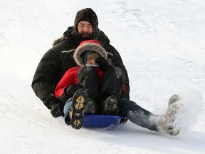 A man applies the footbrake while sliding down Garbage Hill at Westview Park in Winnipeg on Sunday. Winnipeggers get in their outdoor fun while they can as an Alberta clipper is expected to move across the Prairies Monday night, bringing a heavy swath of snow from eastern Saskatchewan southeastward to Lake of the Woods.