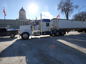 A trucker taking part in the Freedom Convoy rolls past the Manitoba Legislative Building in Winnipeg on Mon., Jan. 24, 2022.  KEVIN KING/Winnipeg Sun/Postmedia Network