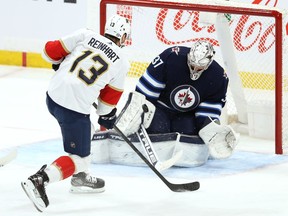 Winnipeg Jets goaltender Connor Hellebuyck stops Florida Panthers centre Sam Reinhart on a breakaway in Winnipeg on Tuesday, Jan. 25, 2022.