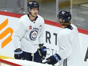 Mark Scheifele and Kyle Connor chat during Winnipeg Jets practice on Wednesday, Jan. 26, 2022.