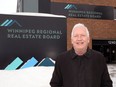 Peter Squire, vice-president of external relations and market intelligence for the Winnipeg Real Estate Board, poses for a photograph at the WREB office on Portage Avenue in Winnipeg on Monday, Jan. 31, 2022.