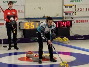 Skip Colton Lott holds the broom during his team's game against Riley Smith at the Manitoba men's curling championship in Selkirk, Man., on Feb. 11, 2022.