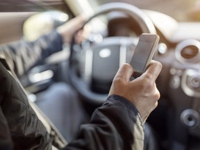 Using a phone in a car texting while driving concept for danger of text message and being distracted.