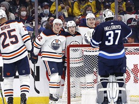 Edmonton Oilers right winger Kailer Yamamoto (56) celebrates his second period goal on Winnipeg Jets goaltender Connor Hellebuyck (37) at Canada Life Centre in Winnipeg.
