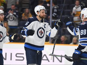 Winnipeg Jets right wing Blake Wheeler (26) celebrates with teammates after defeating the Nashville Predators at Bridgestone Arena in Nashville on Feb. 12, 2022.