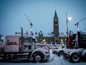 Trucks block a street in front of Parliament Hill during the protest against COVID-19 mandates, in Ottawa on Friday, Feb. 18, 2022.