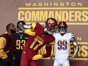 Former players look at the new uniforms during the announcement of the Washington Football Team's name change to the Washington Commanders at FedExField on February 2, 2022 in Landover, Maryland.