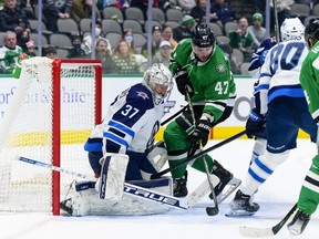 Winnipeg Jets goaltender Connor Hellebuyck makes a save on Dallas Stars winger Alexander Radulov during the second period at the American Airlines Center on Wednesday night. Hellebuyck made 36 saves in all.