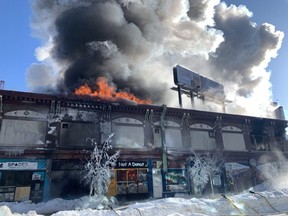 A building at Langside and Portage burns on Wednesday morning, February 2, 2022. Chris Procaylo/Winnipeg Sun