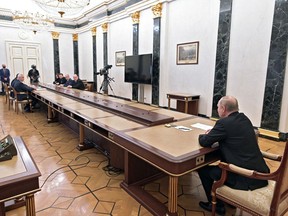 Russian President Vladimir Putin meets with officials to discuss the economic turmoil of the five-day-old war in Ukraine, at the Kremlin in Moscow on February 28, 2022.