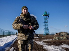 Ukrainian frontier guard patrols an area along the Ukrainian-Russian border in Ukraine's Kharkiv region, Wednesday, Feb. 23, 2022.