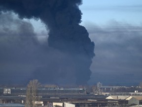 Black smoke rises from a military airport in Chuguyev near Kharkiv, Ukraine, on Feb. 24.