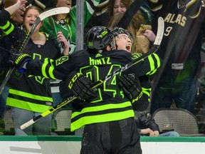 Dallas Stars center Roope Hintz (24) and left wing Jason Robertson (21) celebrate Robertson coring the game winning goal against the Winnipeg Jets during the overtime period at the American Airlines Center in Dallas on Feb. 11, 2022.